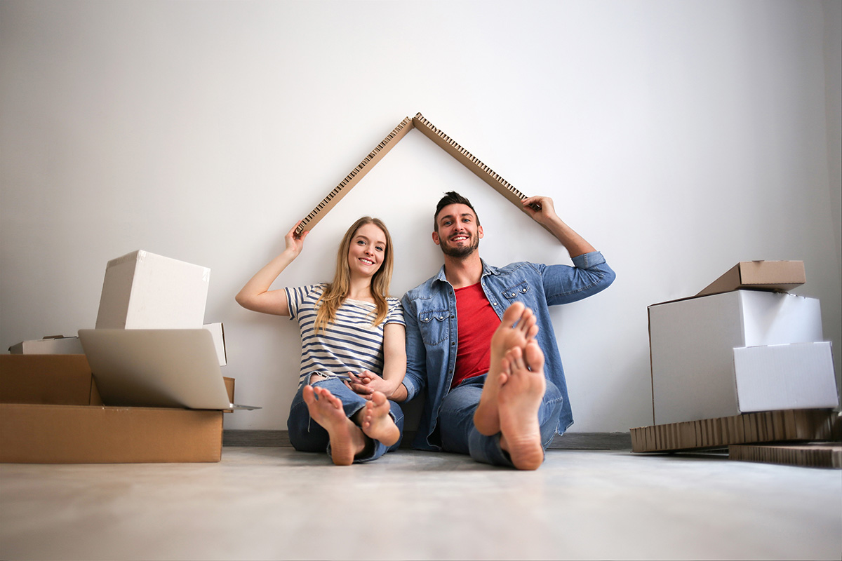 couple unpacking boxes in their newly-moved into home