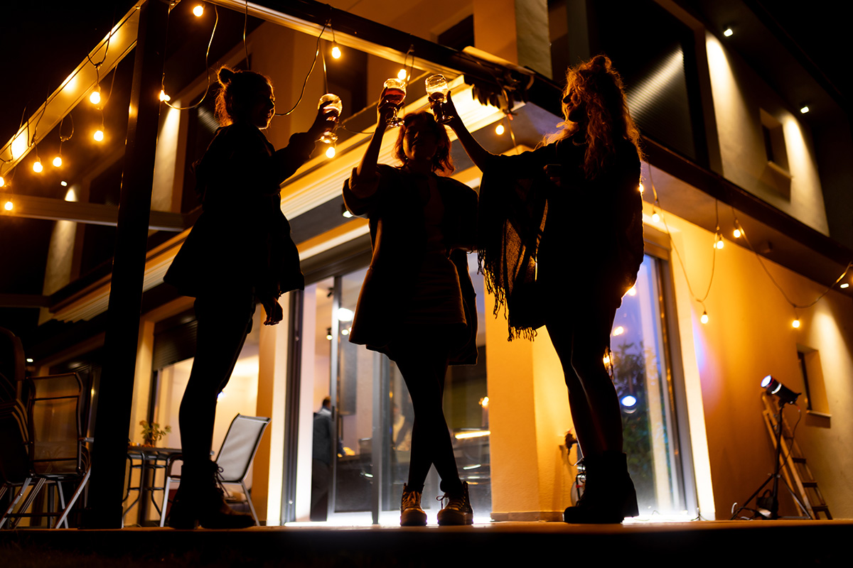 women enjoying drinks in outdoor entertainment area of their house