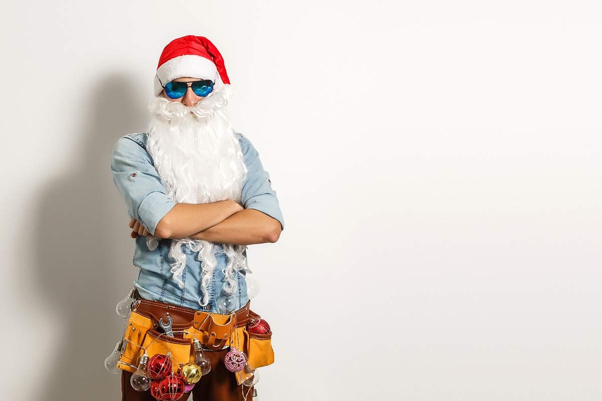 construction worker dressed up in Santa hat and beard