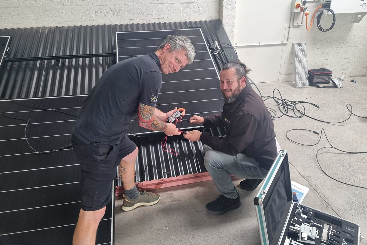 Shamus and Matt installing solar panels